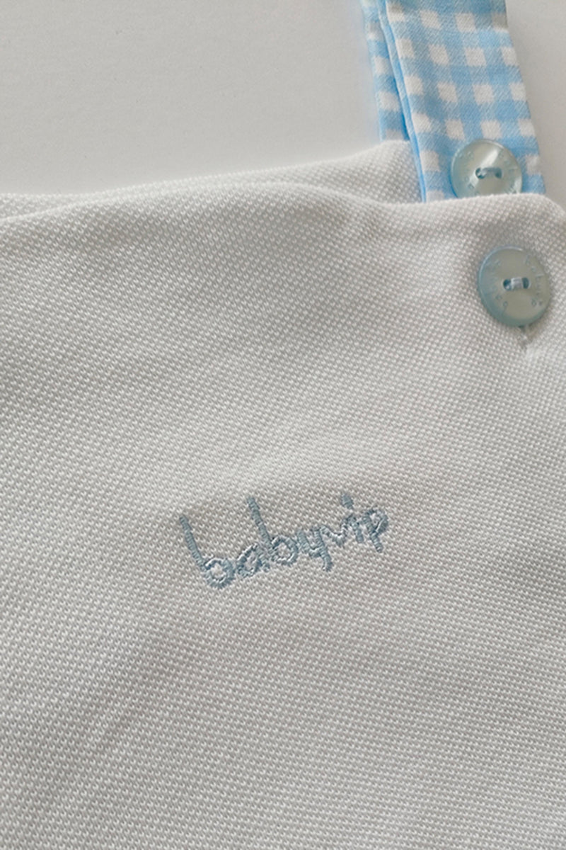 Salopette in cotone a quadri con scritta ricamata
