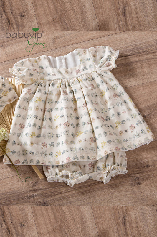 Vestitino neonata in tela di cotone organico con scollo quadro e maniche a palloncino